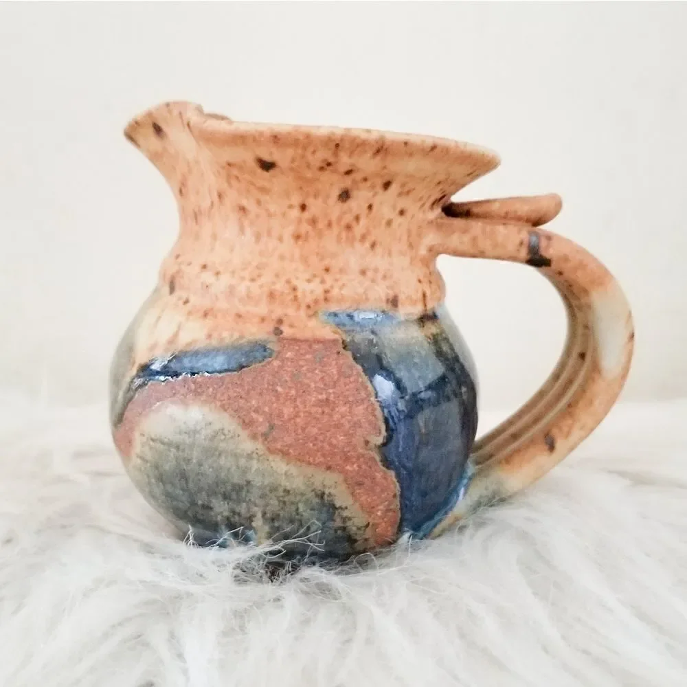 Pottery creamer signed by artist